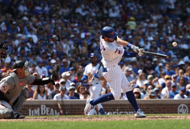 Chicago Cubs shortstop Dansby Swanson hits an RBI single to take the lead against the Baltimore Orioles in the sixth inning Sunday, Aug. 3, 2025, at Wrigley Field. (Brian Cassella/Chicago Tribune)