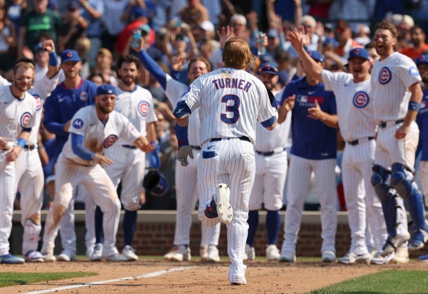 Chicago Cubs teammates wait at home plate for pinch hitter Justin Turner to celebrate his walk-off home run to defeat the Baltimore Orioles, 5-3, on Sunday, Aug. 3, 2025, at Wrigley Field. (Brian Cassella/Chicago Tribune)