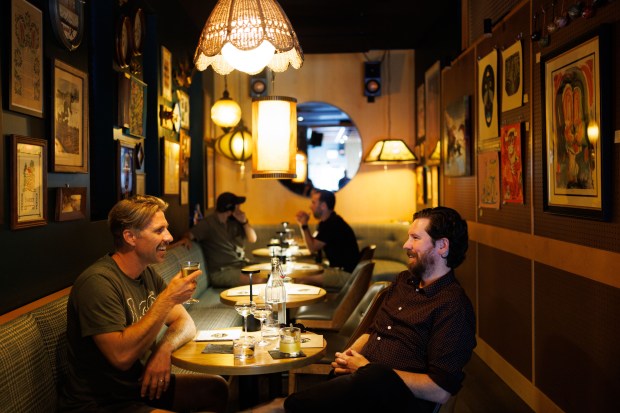 Eric Wandrey, left, and Nick Carlson talk at Charis Listening Bar in Bridgeport, July 9, 2025, in Chicago. (Armando L. Sanchez/Chicago Tribune)