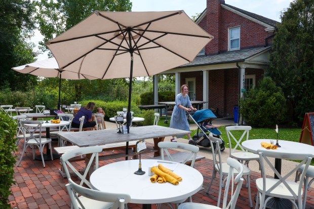 People walk past the Elawa Cafe at the Elawa Farm...