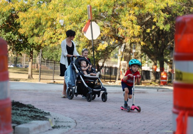 Families maneuver through construction of a raised intersection near Portage Park Elementary at West Berteau and North Long avenues on Sept. 19. 2024, in Chicago. (Stacey Wescott/Chicago Tribune)