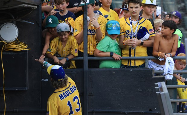 Savannah Bananas player Dalton Mauldin signs autographs before a game against the Firefighters on Aug. 15, 2025, at Rate Field. (John J. Kim/Chicago Tribune)