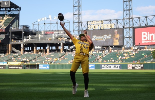 Savannah Bananas player Danny Hosley plays catch with fans before a game against the Firefighters on Aug. 15, 2025, at Rate Field. (John J. Kim/Chicago Tribune)