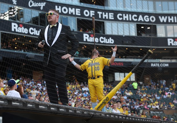 Savannah Bananas player Alex Ziegler balances a bat on his nose before a game against the Firefighters on Aug. 15, 2025, at Rate Field. (John J. Kim/Chicago Tribune)