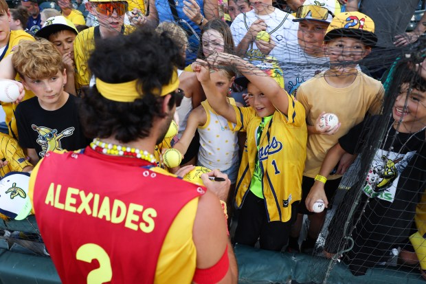 Savannah Bananas player Reese Alexiades signs autographs before a game against the Firefighters on Aug. 15, 2025, at Rate Field. (John J. Kim/Chicago Tribune)