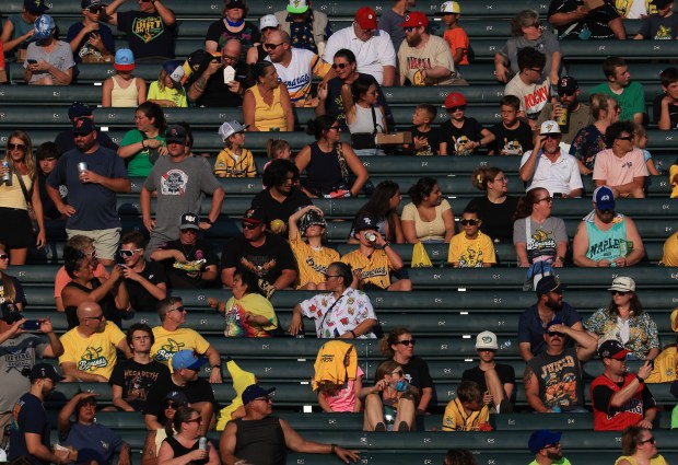 Fans in the bleachers take their seats for a game between the Savannah Bananas and Firefighters on Aug. 15, 2025, at Rate Field. (John J. Kim/Chicago Tribune)