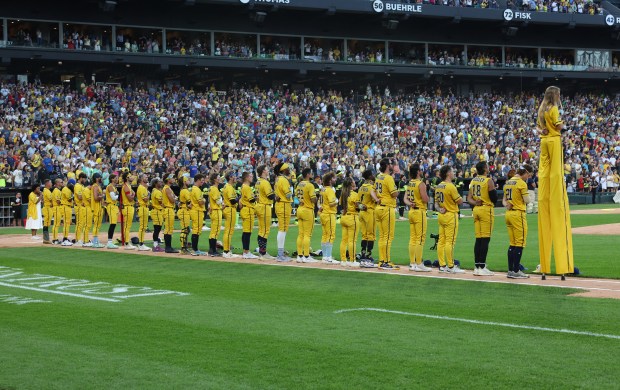 Savannah Bananas players stand for the national anthem before a game against the Firefighters on Aug. 15, 2025, at Rate Field. (John J. Kim/Chicago Tribune)