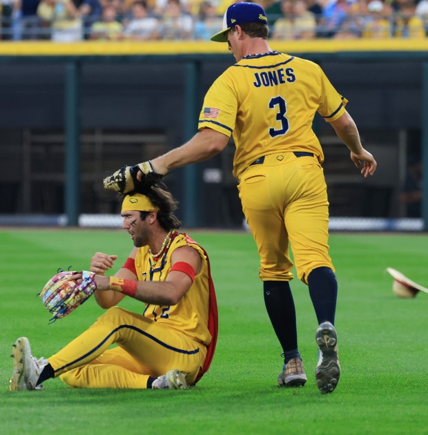 Savannah Bananas player Eric Jones taps his glove on Reese Alexiades's head after catching a popup in the third inning against the Firefighters on Aug. 15, 2025, at Rate Field. (John J. Kim/Chicago Tribune)