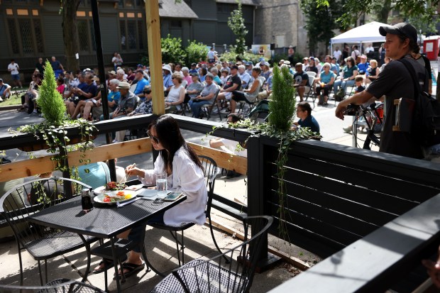 A person dines outside at Fin sushi bar while enjoying...