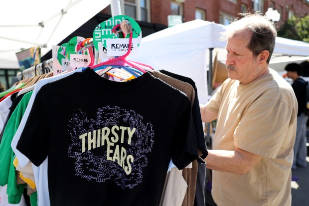 A Thirsty Ears T-shirt is seen hanging as a person...
