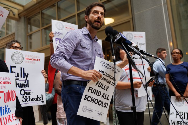 Chicago Teachers Union Vice President Jackson Potter speaks with members of the press outside Chicago Public Schools headquarters while CPS holds public budget hearings on Aug. 19, 2025. (Armando L. Sanchez/Chicago Tribune)