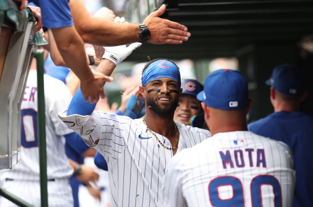 Chicago Cubs second baseman Willi Castro celebrates with his teammates in the dugout after hitting a 3-run home run in the third inning of Game 1 of a doubleheader against the Milwaukee Brewers at Wrigley Field in Chicago on Aug. 19, 2025. (Chris Sweda/Chicago Tribune)
