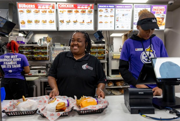 Employees Michelle Crayton, left, and Deajana Logan serve food and wait on customers at a Jack in the Box restaurant, Aug. 7, 2025, in Plainfield. (Brian Cassella/Chicago Tribune)
