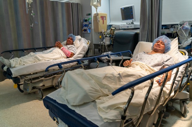 Brothers Alfredo Pacheco, left, and José Gregorio González prepare for a living kidney transplant on Aug. 14, 2025, at University of Illinois Hospital. (Hoss Fatemi/UI Health Marketing)