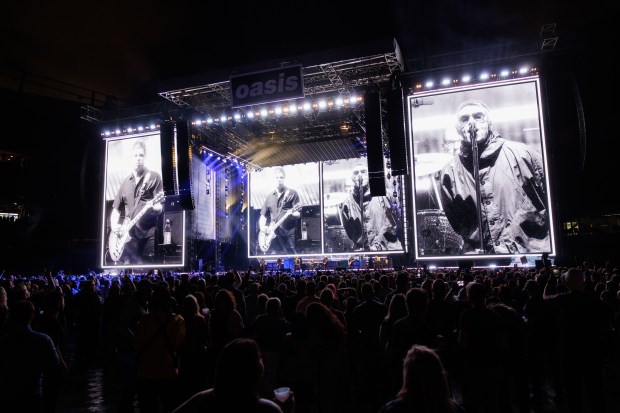 Fans watch Oasis perform a Soldier Field on Aug. 28,...