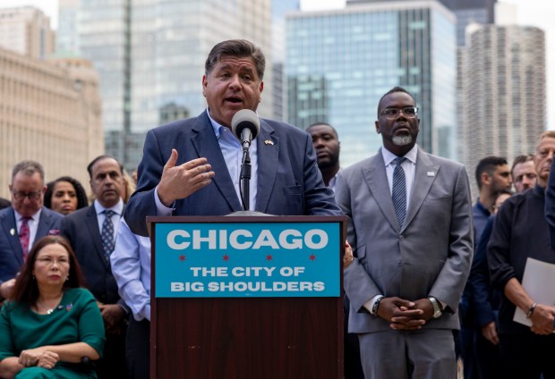 Gov. JB Pritzker and Mayor Brandon Johnson take questions Monday, Aug. 25, 2025, along the Chicago River as city, state and federal leaders denounced President Donald Trump's possible military deployment into the city. (Brian Cassella/Chicago Tribune)