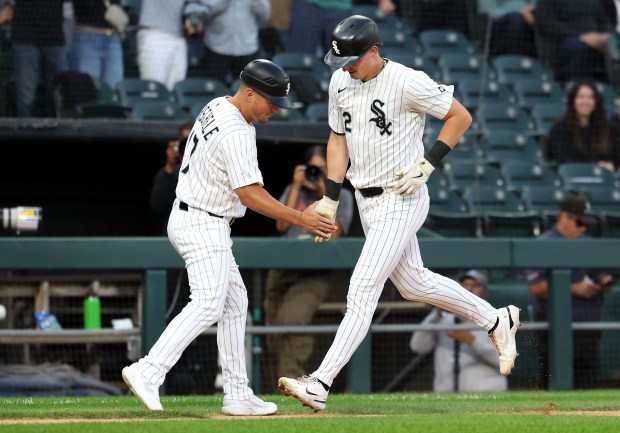 Chicago White Sox shortstop Colson Montgomery is congratulated by third base coach Justin Jirschele after Montgomery hit a solo home run in the second inning of a game against the Kansas City Royals at Rate Field in Chicago on Aug. 26, 2025. (Chris Sweda/Chicago Tribune)