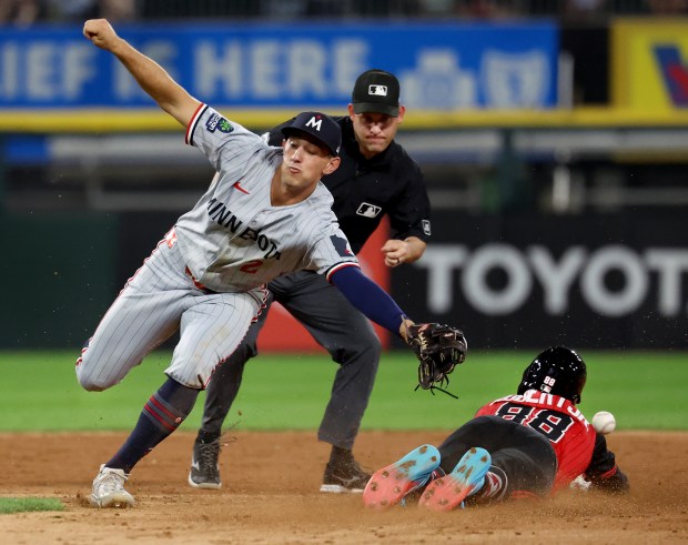 Minnesota Twins shortstop Brooks Lee (2) is unable to catch a ball as Chicago White Sox center fielder Luis Robert Jr. (88) steals second base in the fifth inning of a game at Rate Field in Chicago on Aug. 22, 2025. (Chris Sweda/Chicago Tribune)