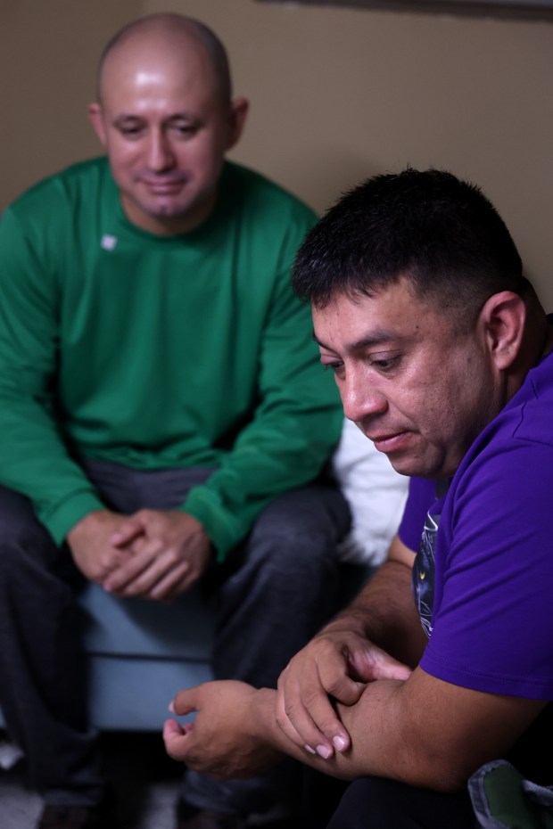 Brothers José Gregorio Gonzalez, left, and Alfredo Pacheco, wait in their basement apartment in Cicero before heading to the hospital for their kidney transplant surgery on Aug. 14, 2025. (Antonio Perez/Chicago Tribune)