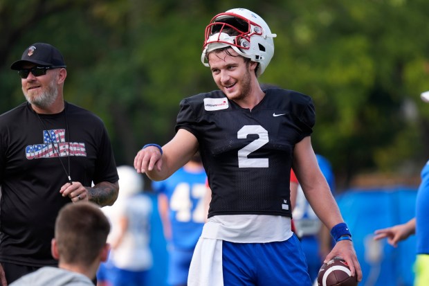 Then-SMU quarterback Preston Stone smiles while talking with teammates during practice Aug. 9, 2024, in Dallas. Stone transferred to Northwestern in January. (LM Otero/AP)