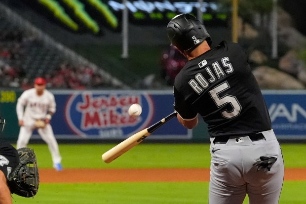 Chicago White Sox's Josh Rojas hits a solo home run as Los Angeles Angels third baseman Yoán Moncada watches during the ninth inning of a baseball game Friday, Aug. 1, 2025, in Anaheim, Calif. (AP Photo/Mark J. Terrill)