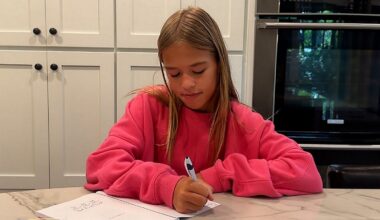 Carsyn Todd signing copies of her book ‘Young Heroes, Big Hearts’ at home. sharing kindness with every page (Spectrum News 1/Aliah Keller).