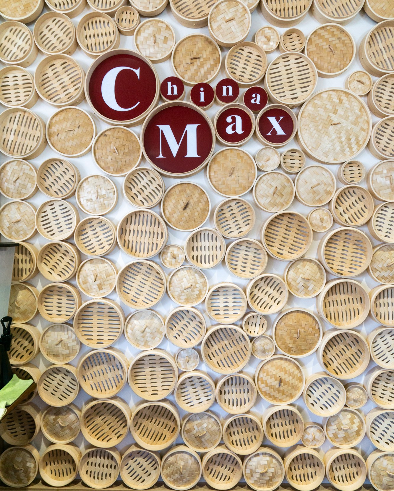 Wall of steamer baskets at China Max with name in the middle