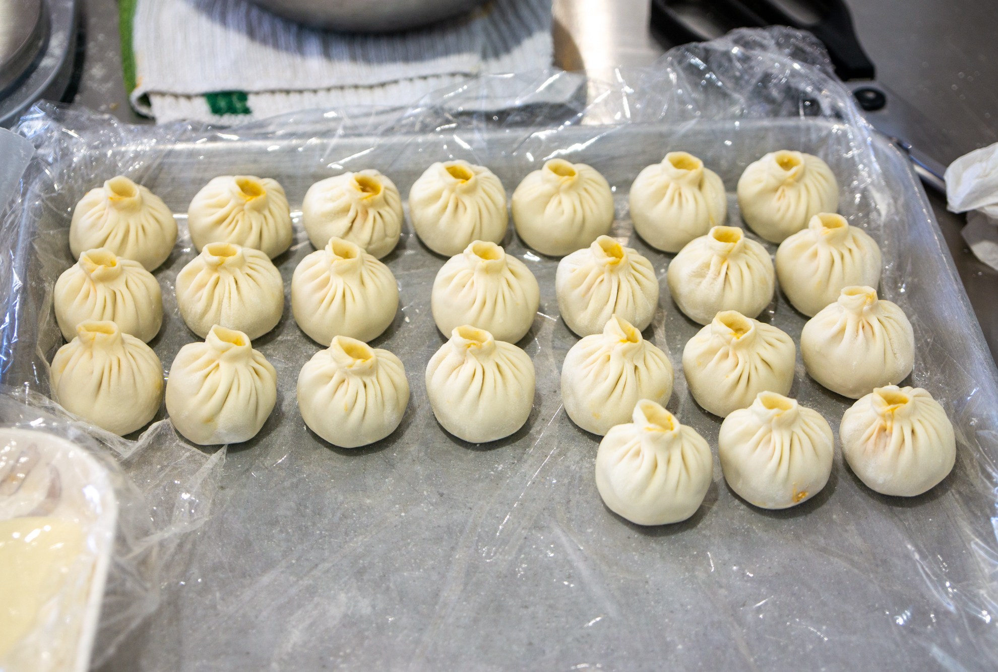 Rows of dumplings on a sheet tray at China Max