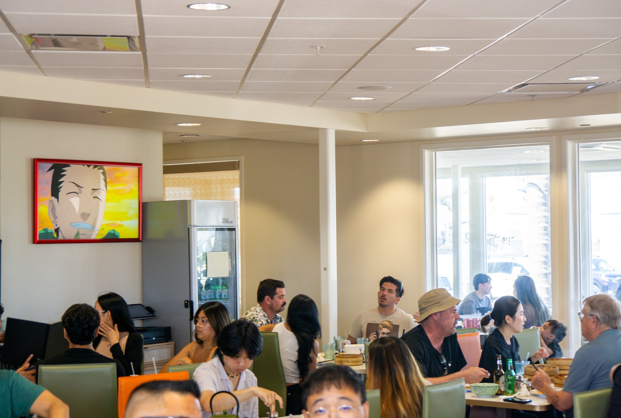 Interior of China Max Dumpling House with anime on the television and guests dining