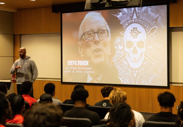 San Diego State football coach Sean Lewis listed off the accomplishments of Steve Fisher before the former SDSU men's basketball coach spoke to the football team. (Justin Truong / SDSU Athletics)