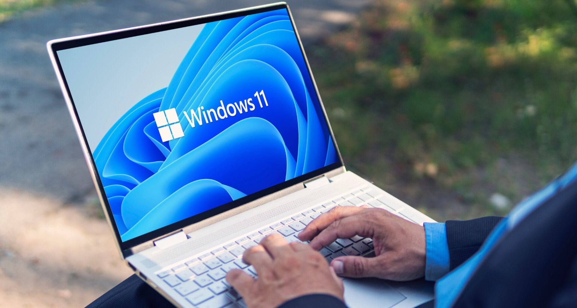 Man typing on Windows 11 laptop