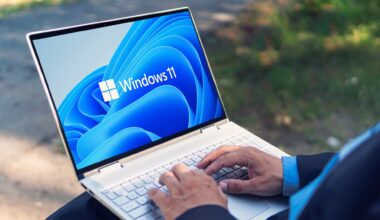 Man typing on Windows 11 laptop