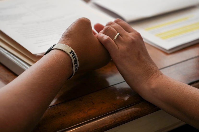 Reasa Selph holds hands with her son Nicholas Mata during an interview on Monday, July 14,...
