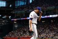 Rangers pitcher Jacob deGrom walks to the dugout after a pitching change during the game...