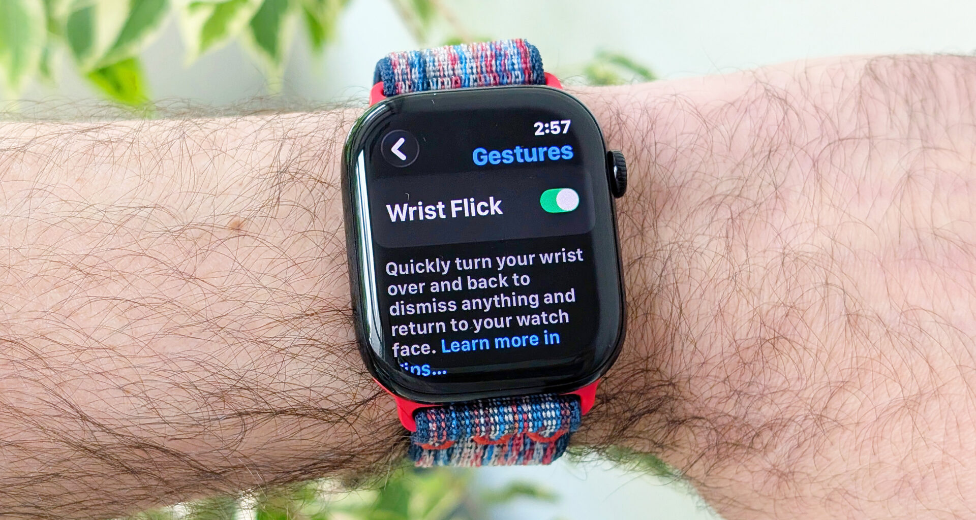 Close-up of the Apple Watch Series 10 on a user's wrist showing the new wrist flick gesture used to dismiss notifications hands free