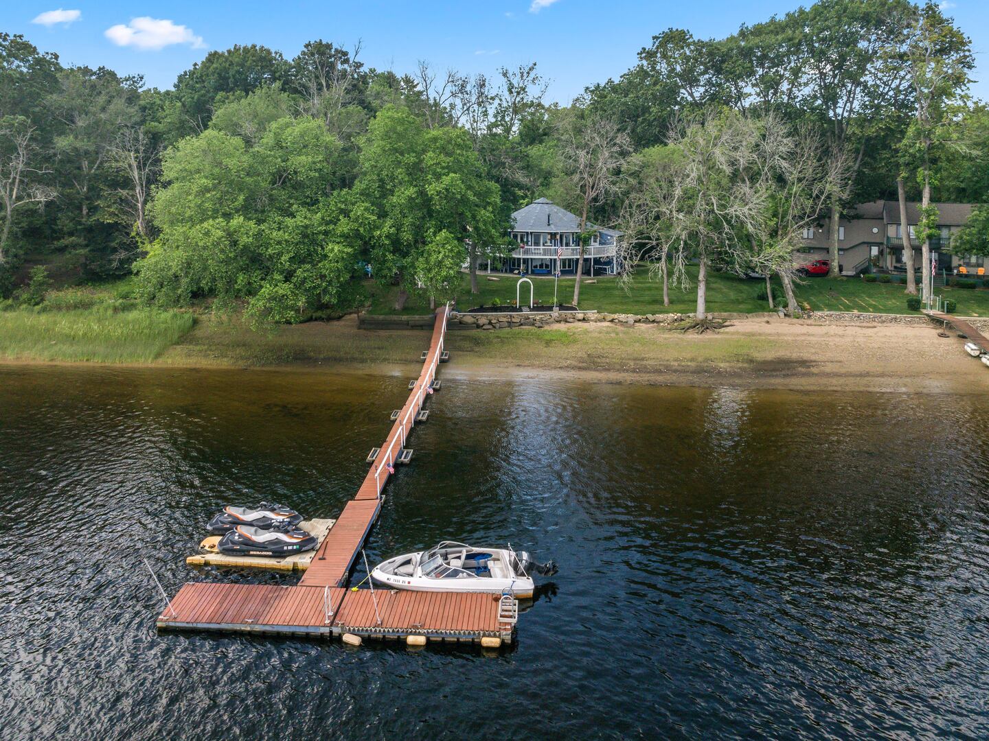 This drone view of the property shows the dock that extends 120 feet out from the yard and has room for boats and jet skis.