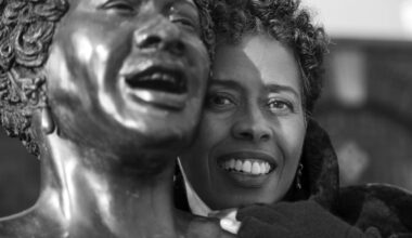 Vinnie Bagwell pictured with the life-size bronze statue of singer Ella Fitzgerald  titled "The First Lady of Jazz"  at the Yonkers Metro-North Station.