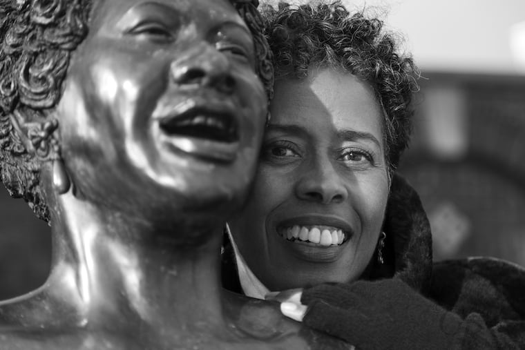 Vinnie Bagwell pictured with the life-size bronze statue of singer Ella Fitzgerald  titled "The First Lady of Jazz"  at the Yonkers Metro-North Station.