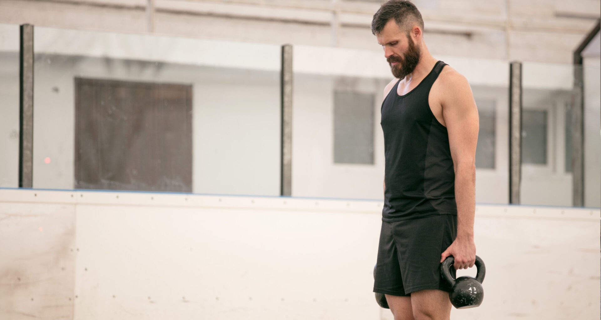 A man performing the core exercise farmer carries