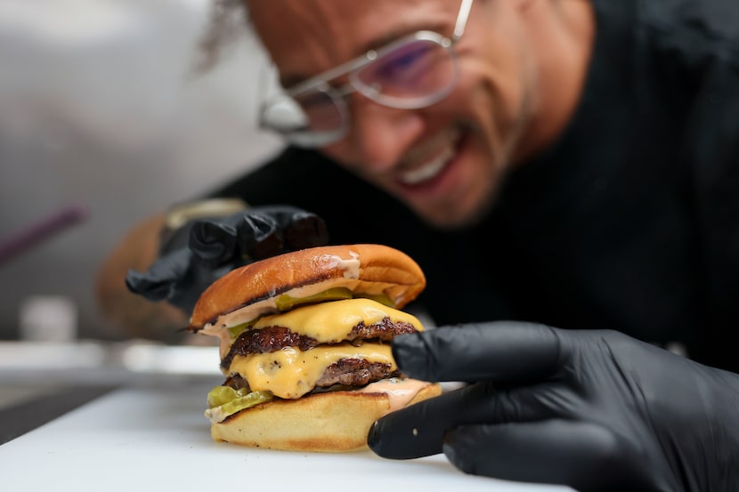 Neen Williams, co-founder of NADC Burger, is ready for his first bite.