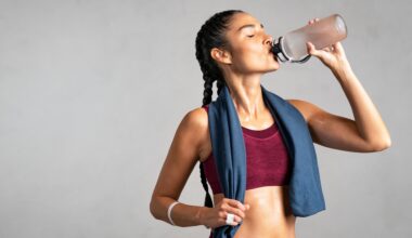 woman drinking water post-workout