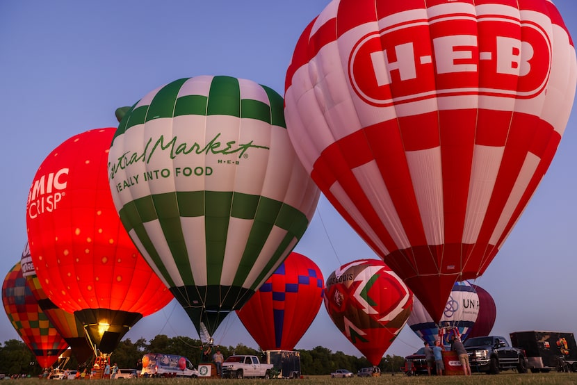 Hot air balloons light up in turn to complement a performance by the Plano Symphony...