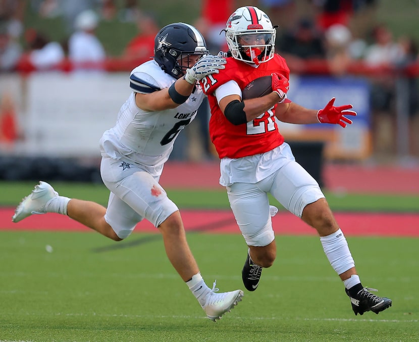 Argyle running back Logan Rexroat (21) tries to get around the corner from Frisco Lone Star...