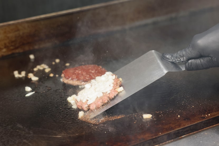 Next come the diced yellow onions, which are pressed into each NADC Burger patty, then...