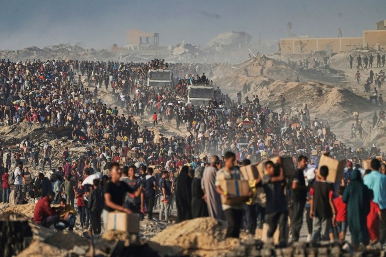Gaza residents carry food