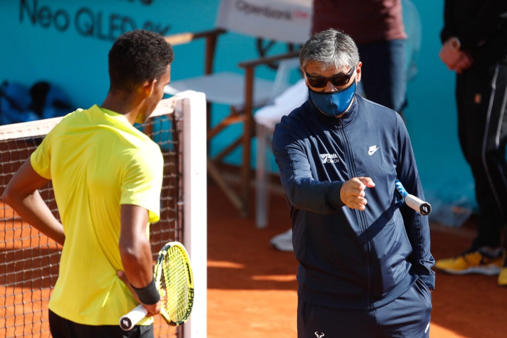 Toni Nadal, head coach, talks to Felix Auger-Aliassime of Canada during his practice on day two of the ATP Masters 1000 - Mutua Madrid Open 2021 at La Caja Magica.
