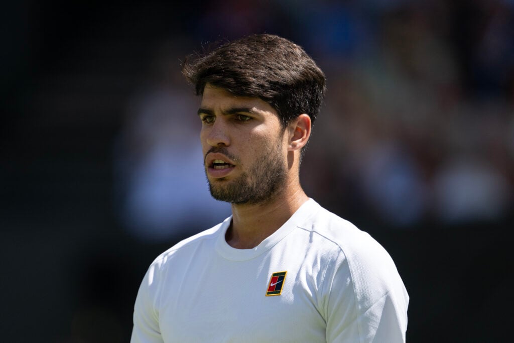 Carlos Alcaraz of Spain looks on against Taylor Fritz of United States during the Gentlemen's semi-final match on day twelve of The Championships Wimbledon 2025 at All England Lawn Tennis and Croquet Club.