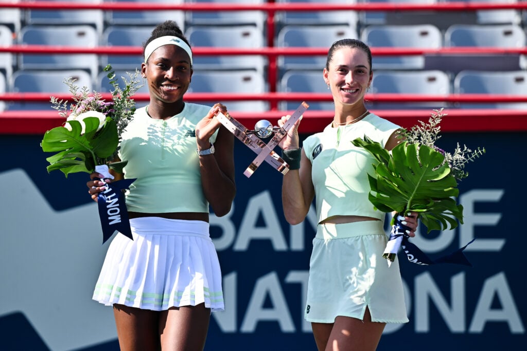 Coco Gauff and McCartney Kessler take photos with the 2025 WTA 1000 National Bank Open trophy