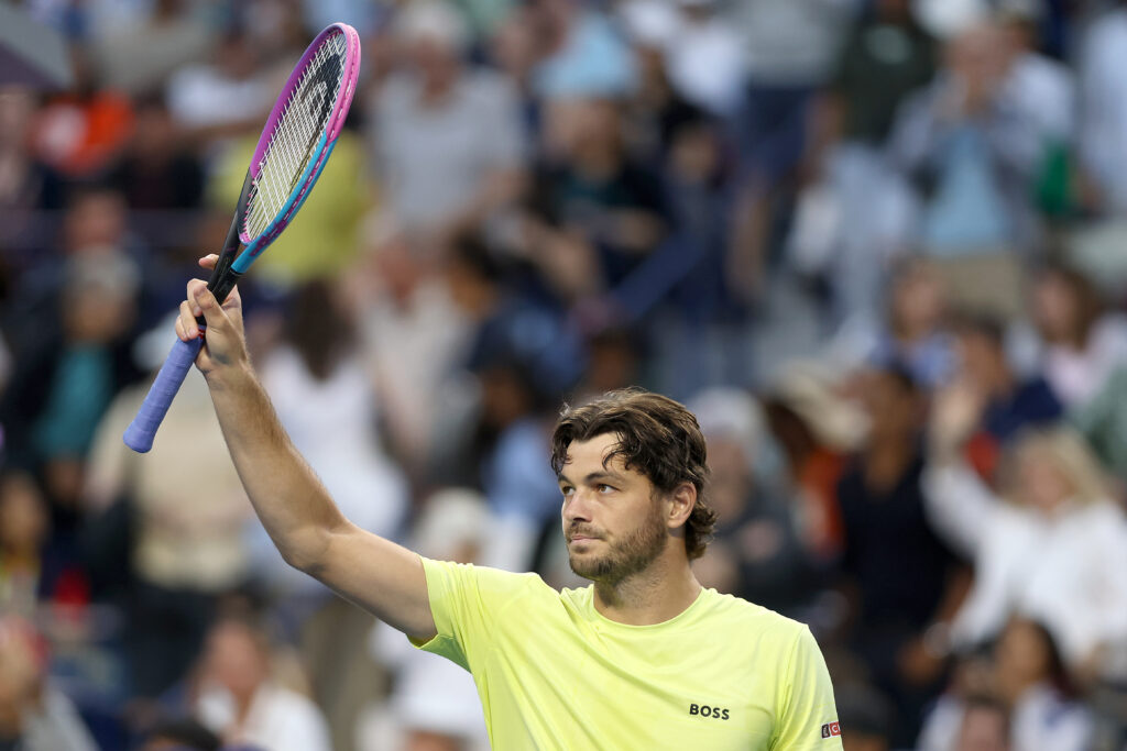 Taylor Fritz waves with his racket to the fans