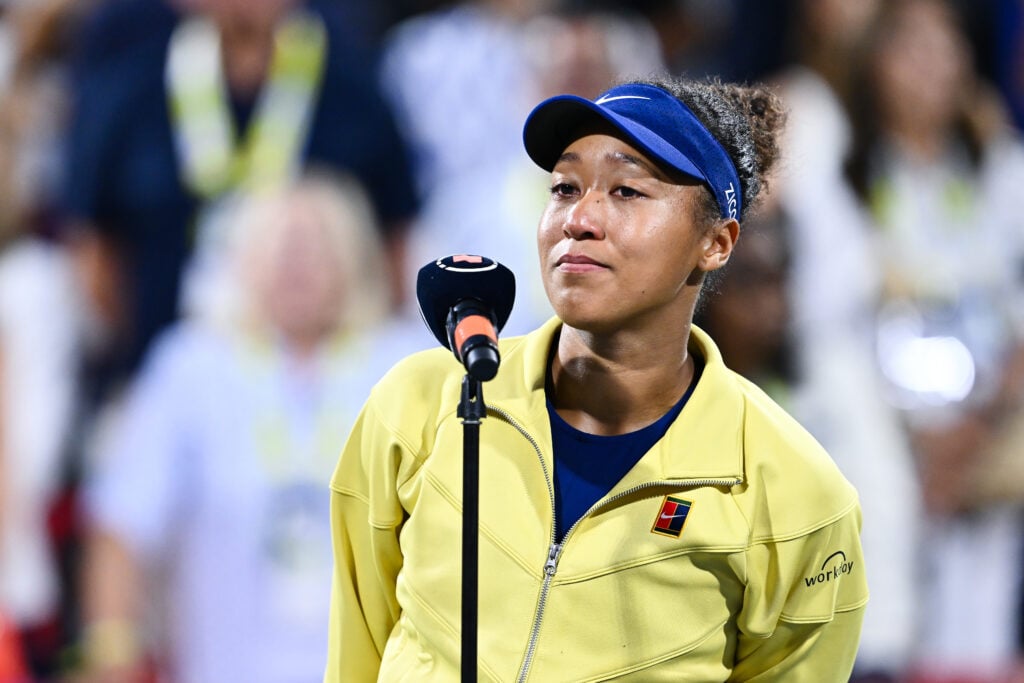 Naomi Osaka speaks into a microphone